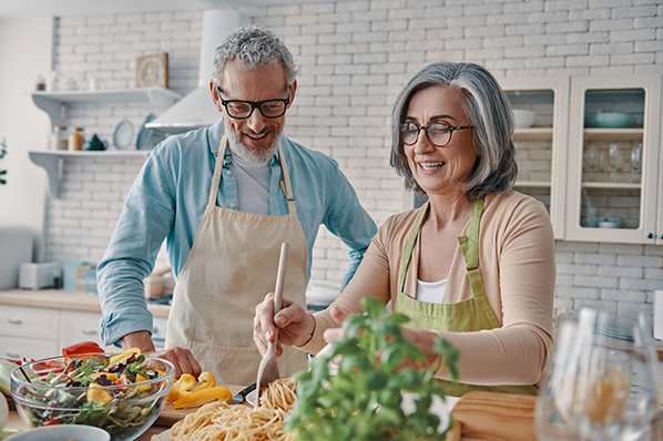 retired couple cooking in kitchen